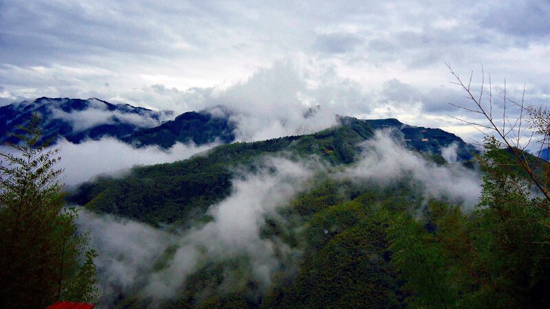 Clouds over green mountains
