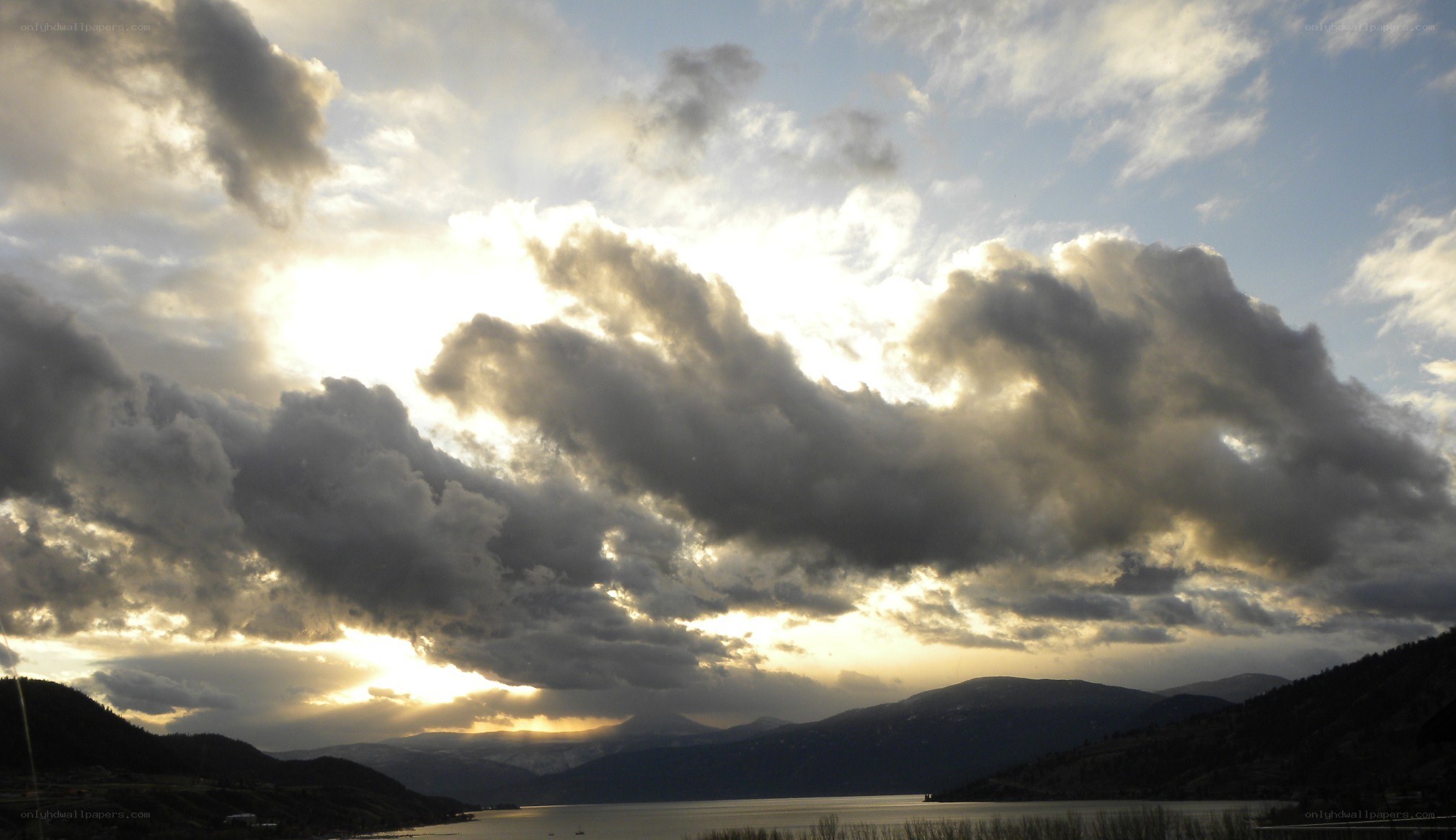 clouds over lake and mountains
