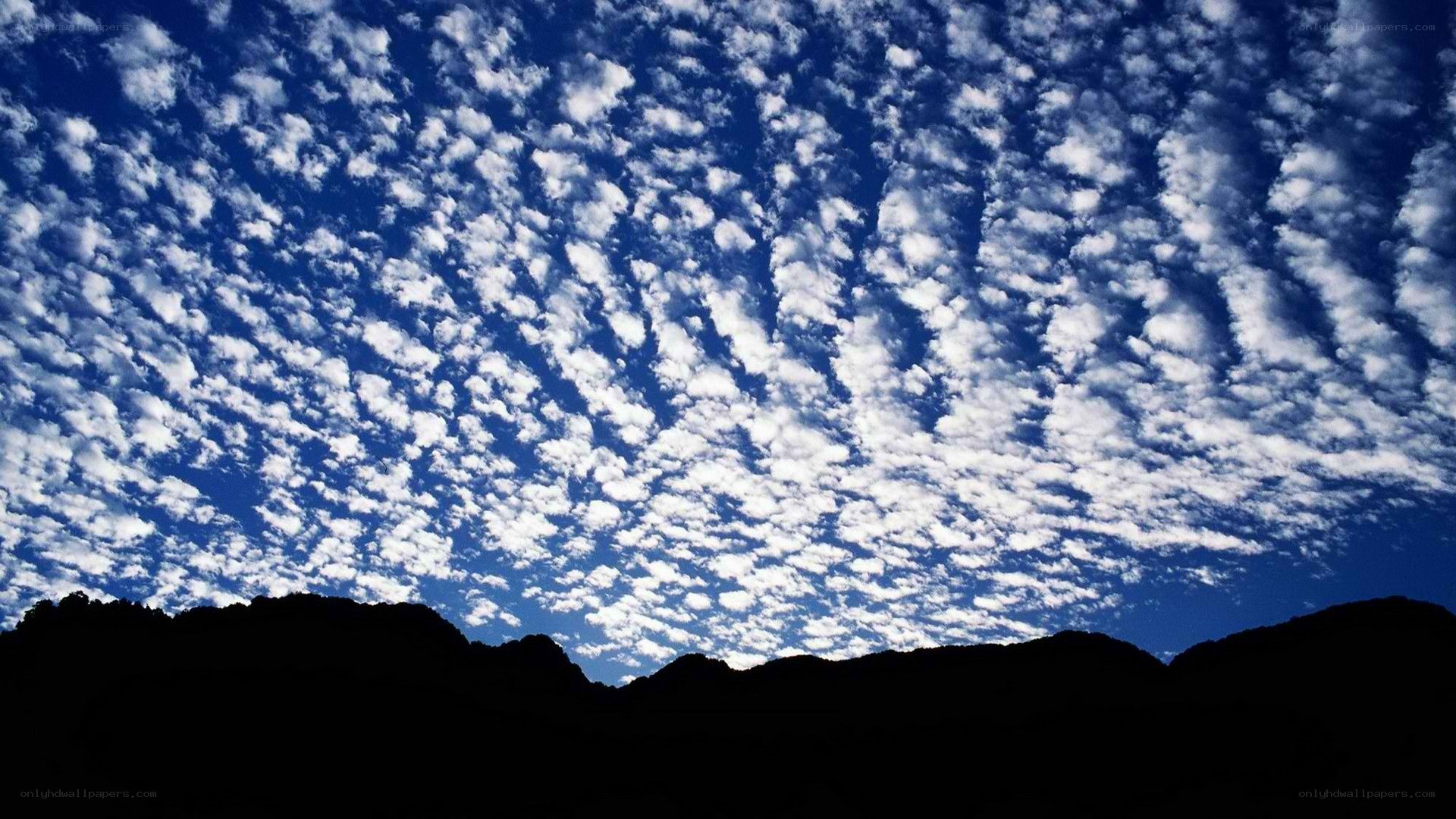 clouds over mountain silhouette