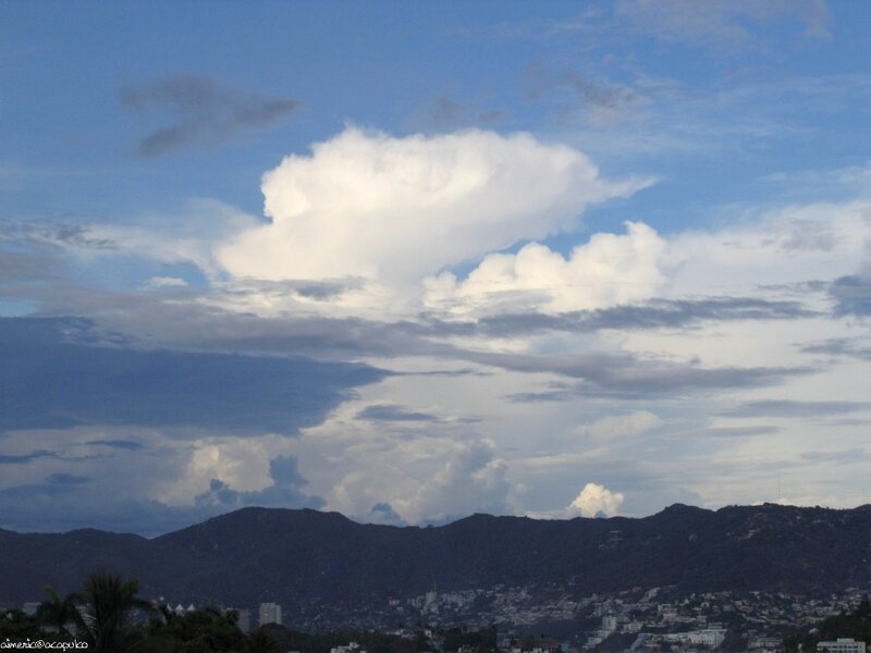 Clouds over mountains and city