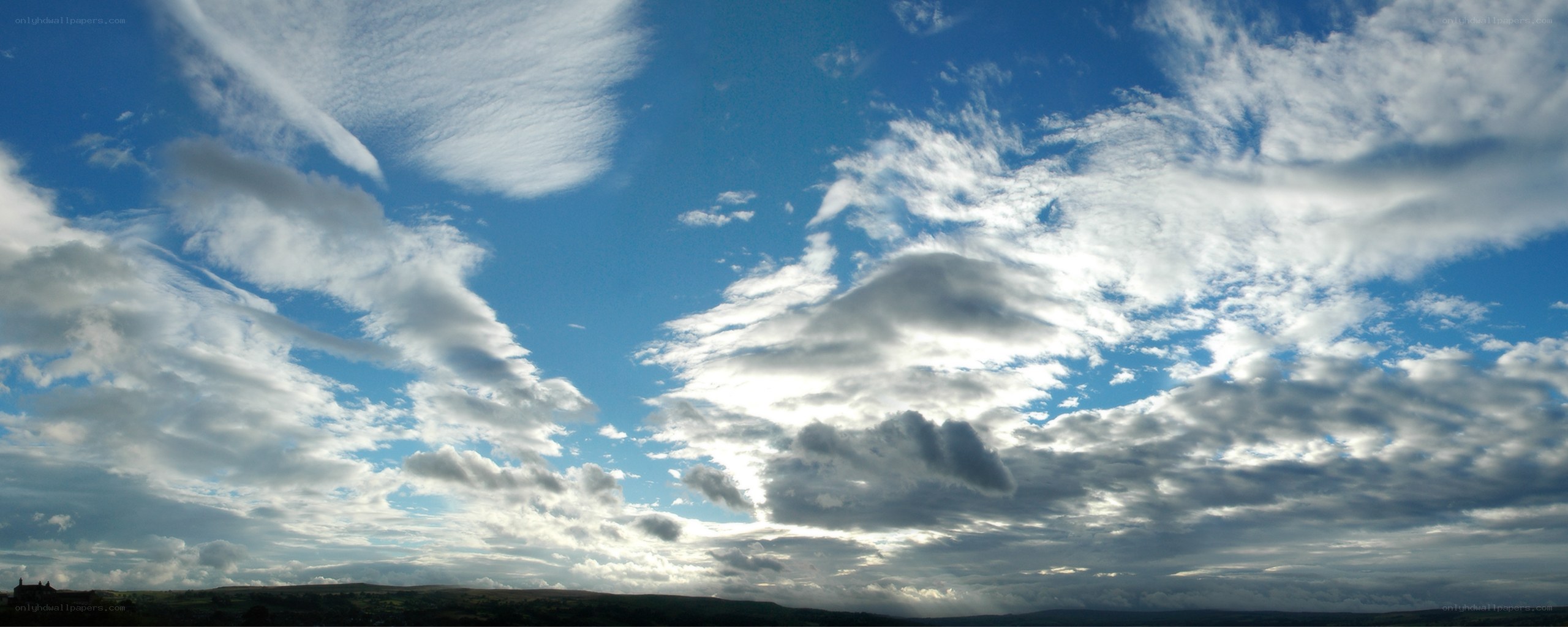 Clouds over rolling hills