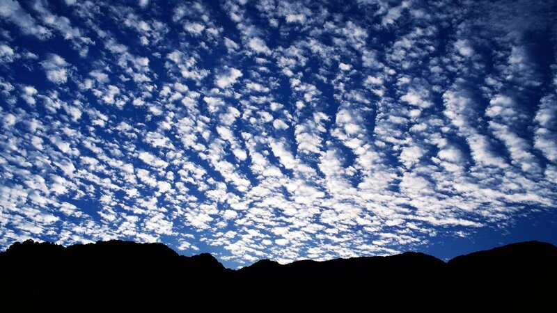 Clouds over silhouetted mountains