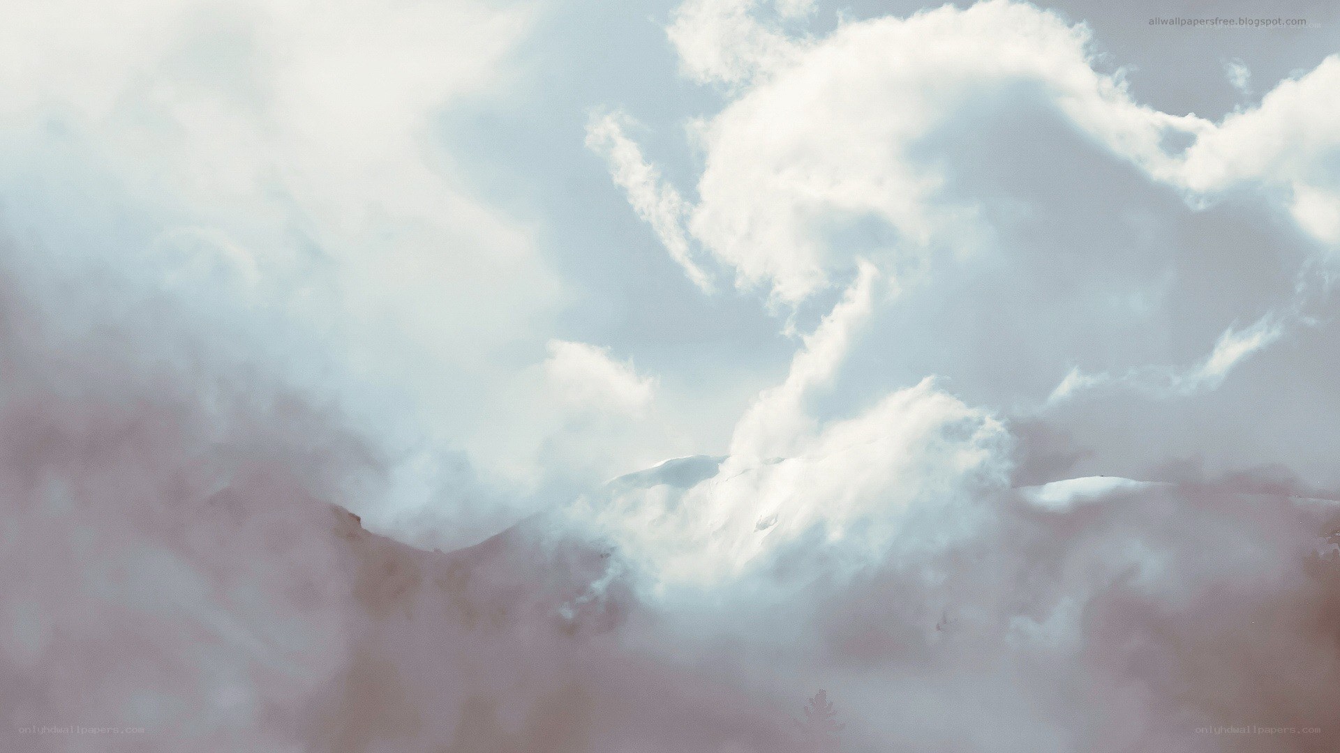 Clouds over snowy mountains