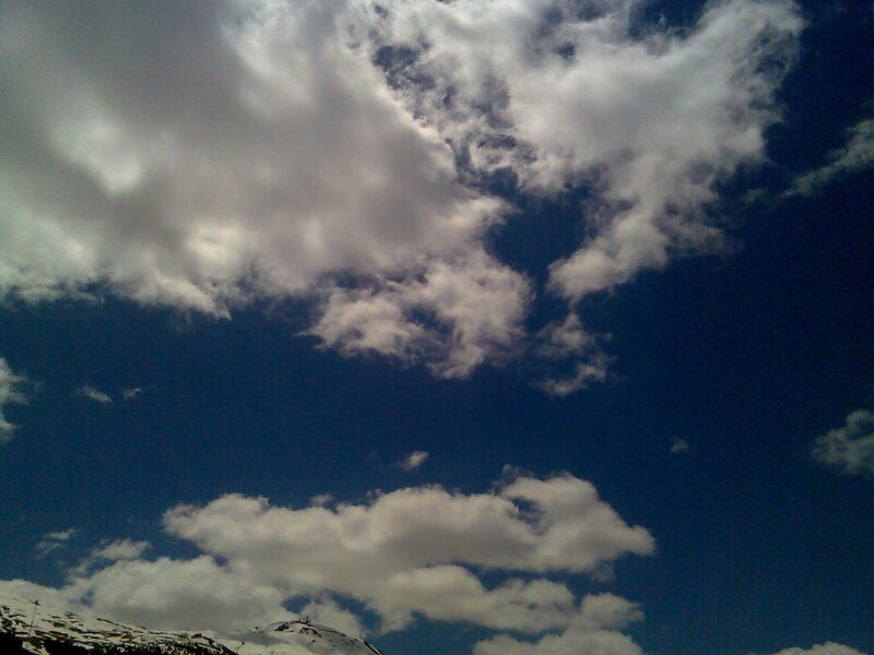 Clouds over snowy mountains