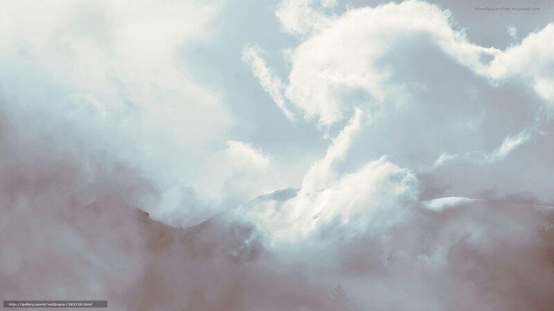 clouds over snowy mountains