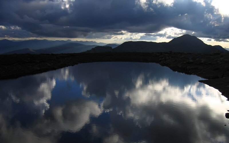 Clouds reflected in mountain pond