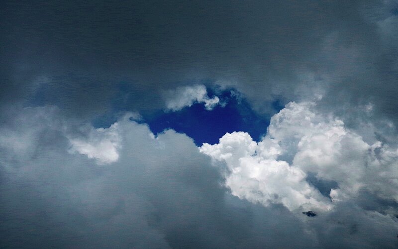 clouds with blue sky peeking through