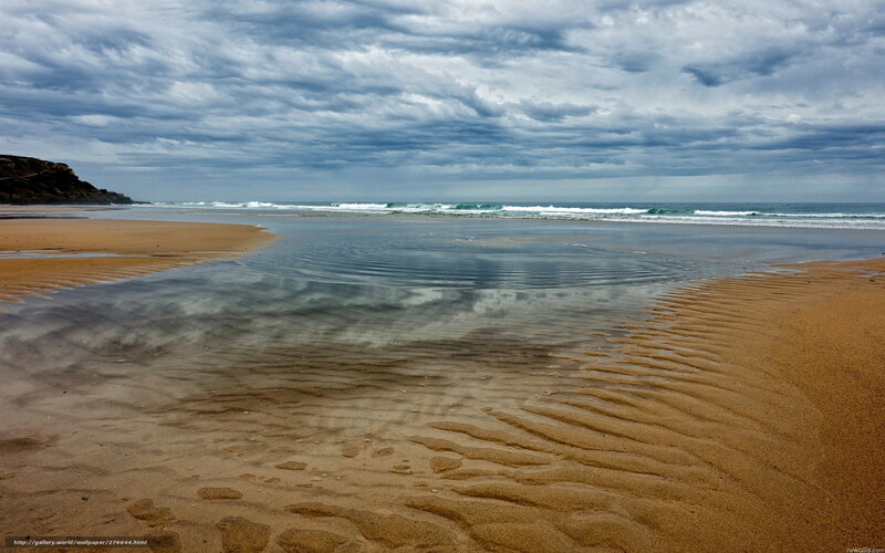 Cloudy beach with tide pools