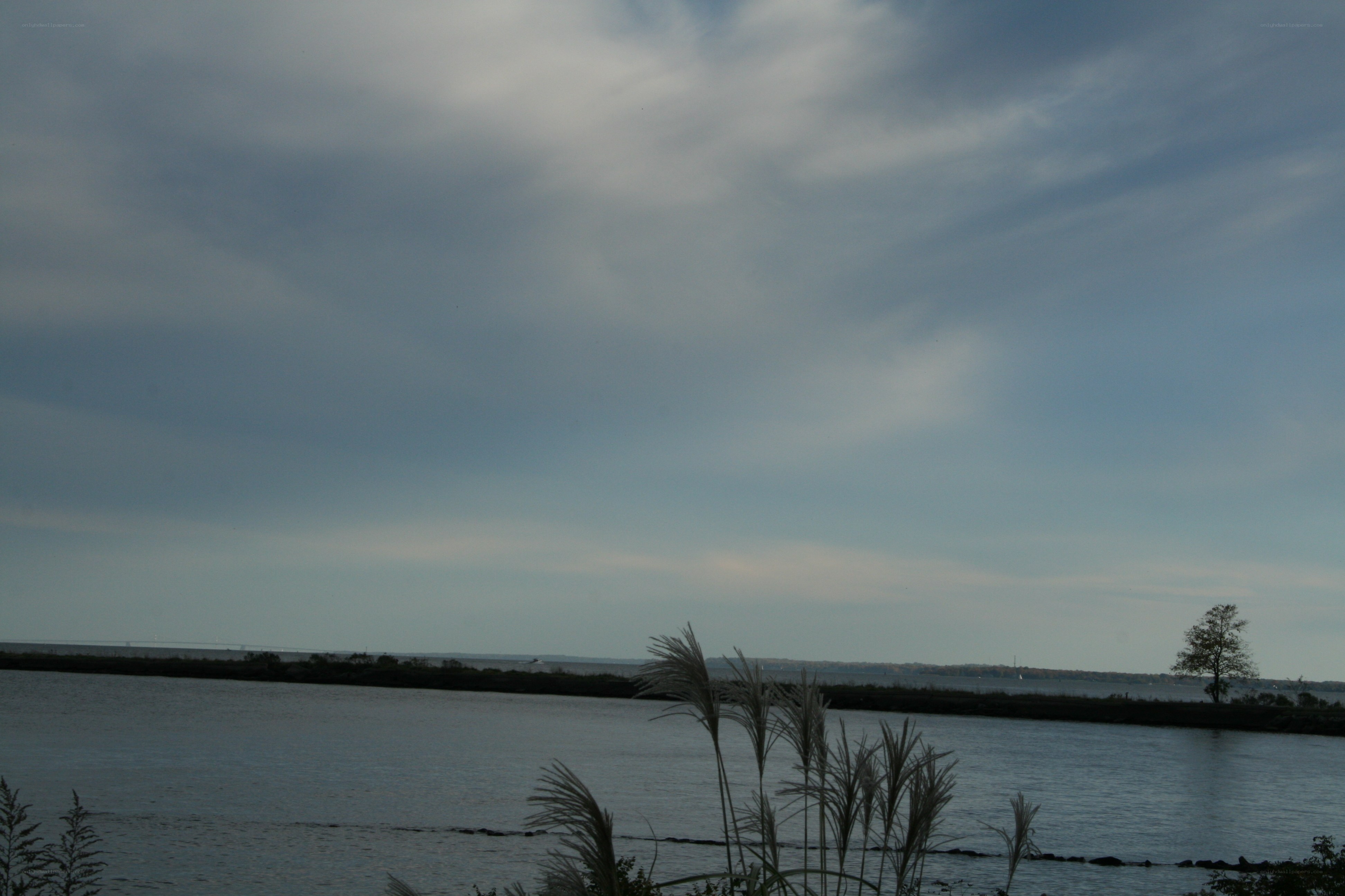 Cloudy sky over a calm waterway