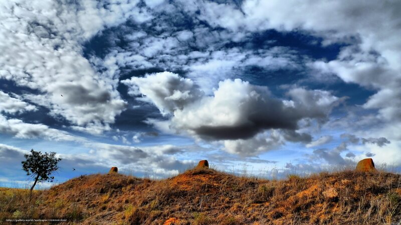 Cloudy sky over a hill