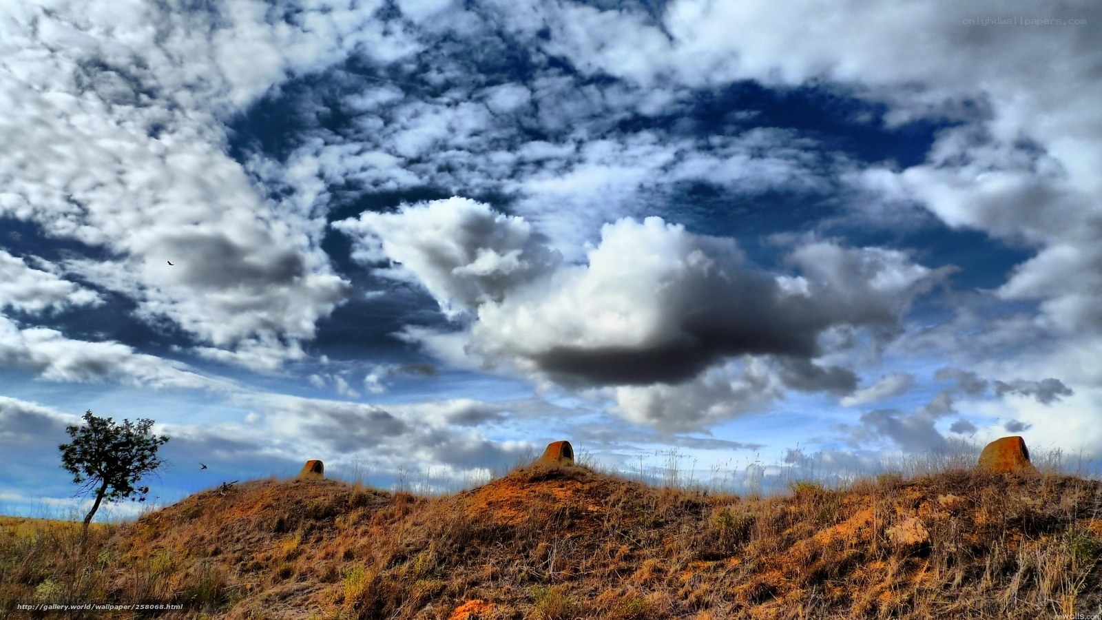 Cloudy sky over a hill