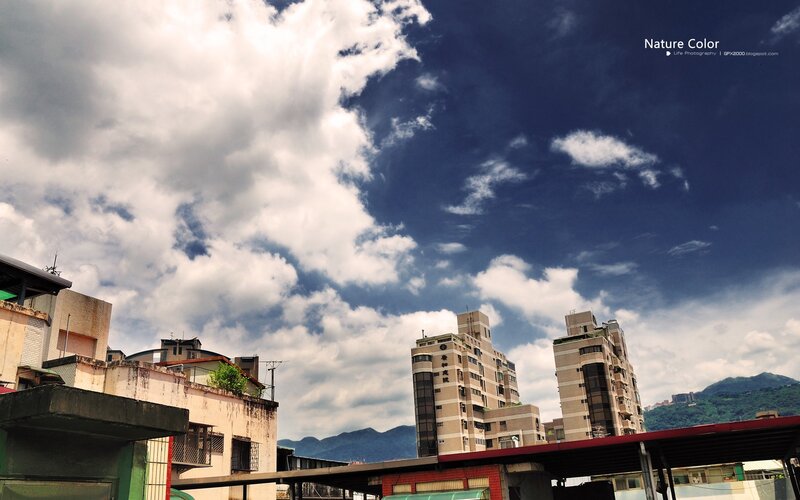 Cloudy sky over city buildings