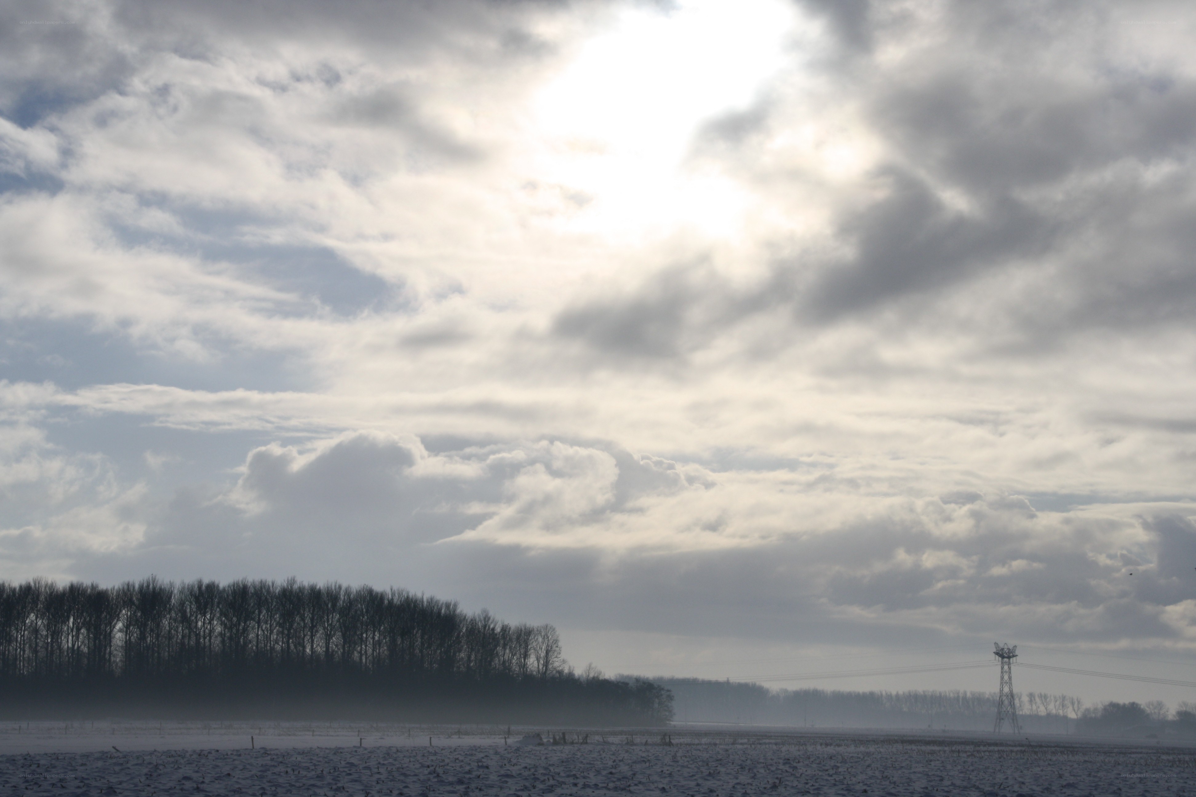 Cloudy sky over snowy field