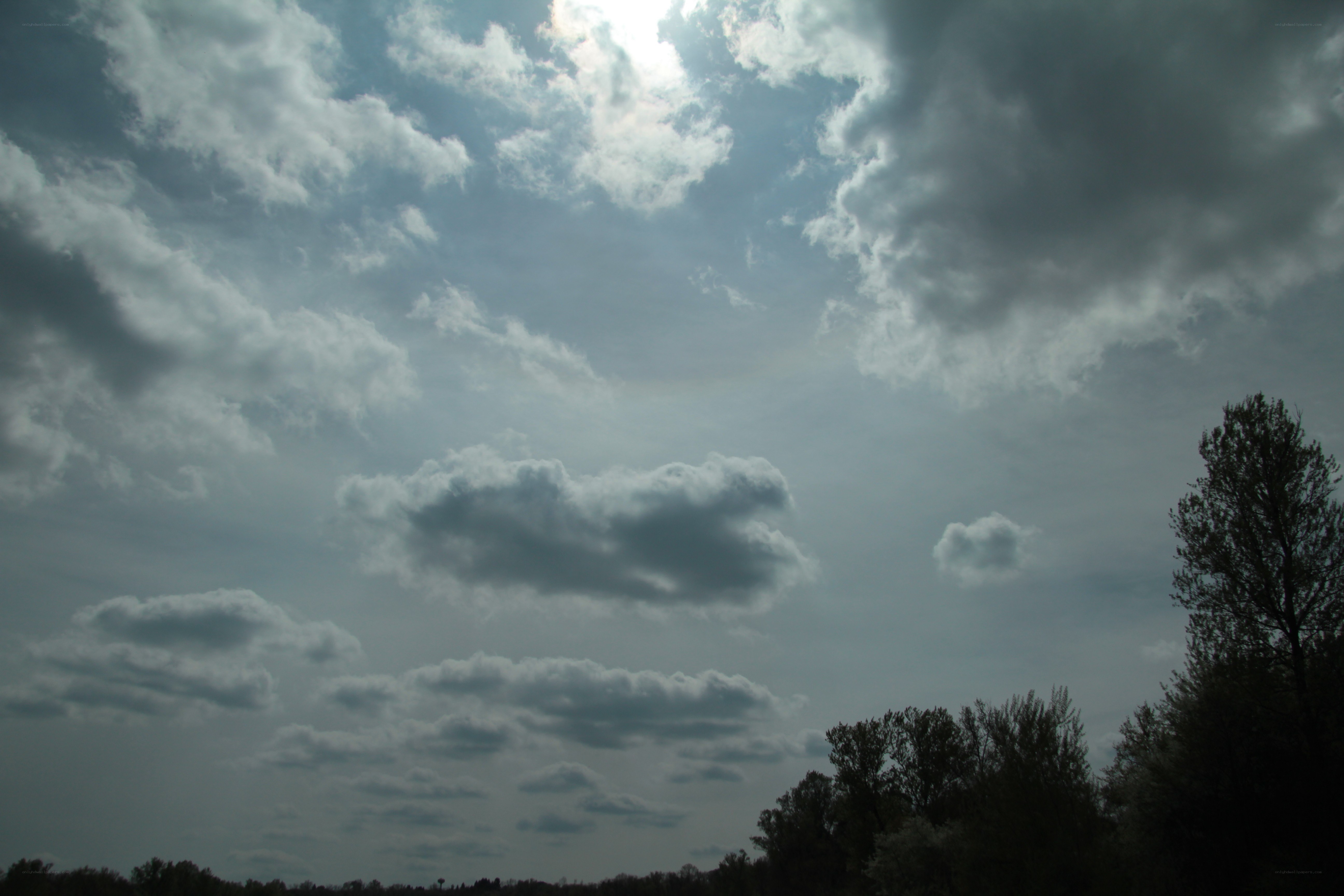 Cloudy sky with sun peeking through