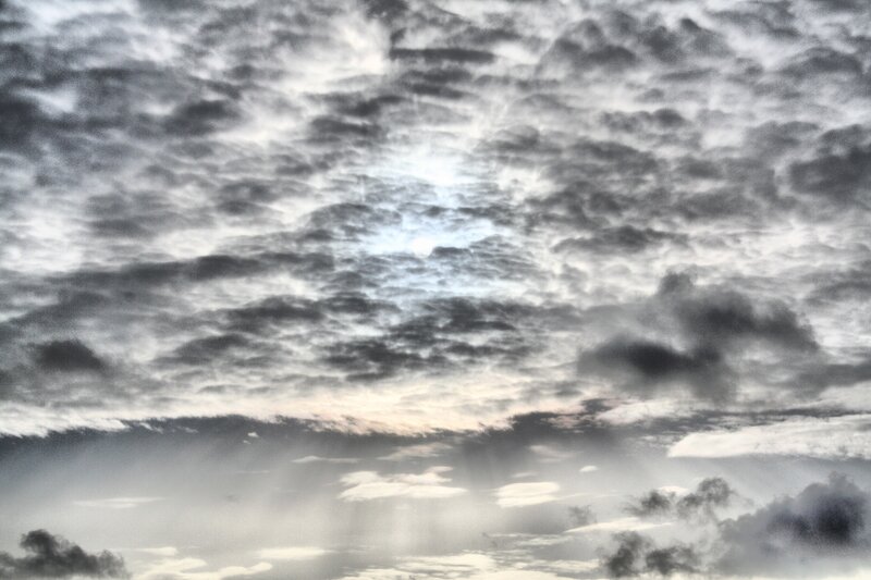 Cloudy sky with sun rays