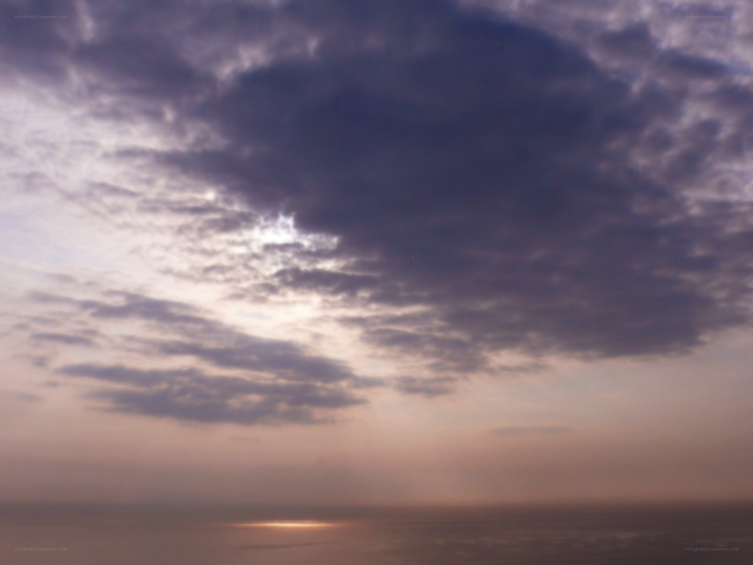 cloudy sunset over water
