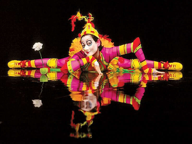 Clown performer on reflective surface