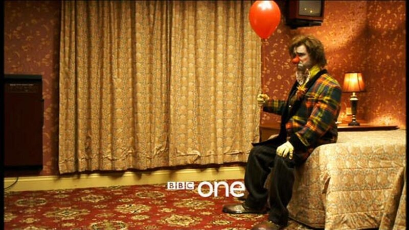 clown sitting in a hotel room