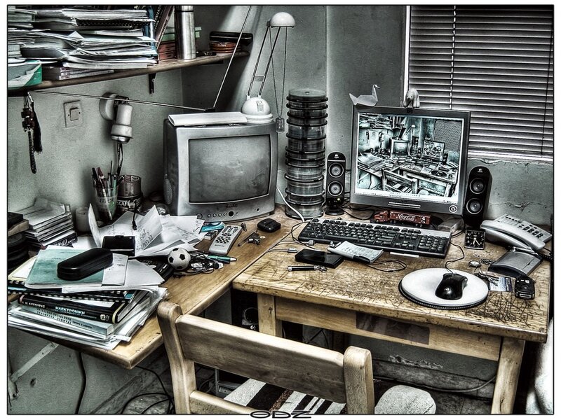 cluttered computer desk workspace