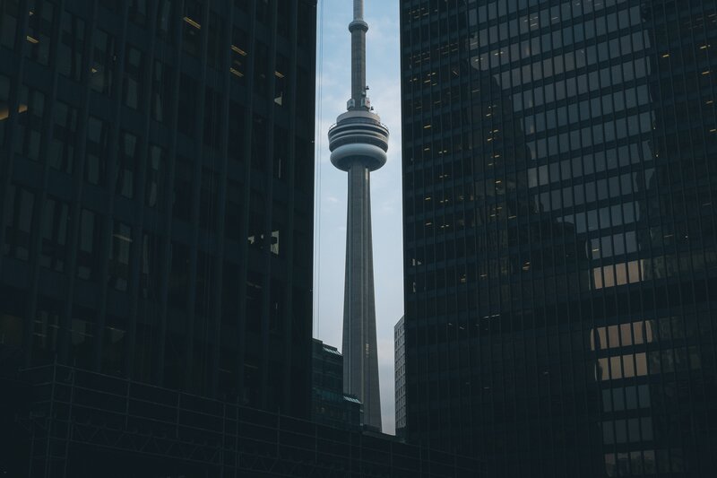 CN Tower between skyscrapers