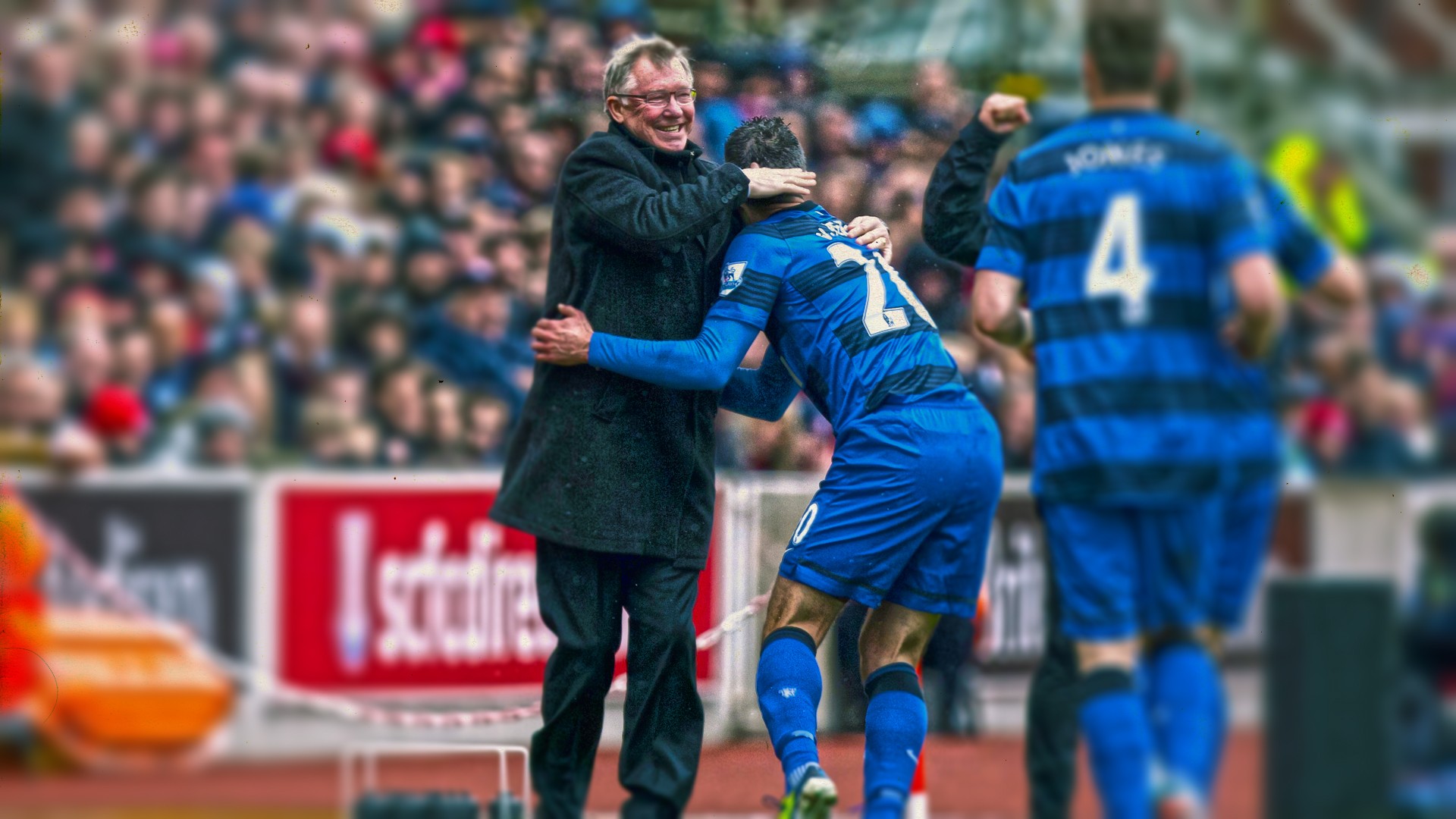 Coach hugging player on field