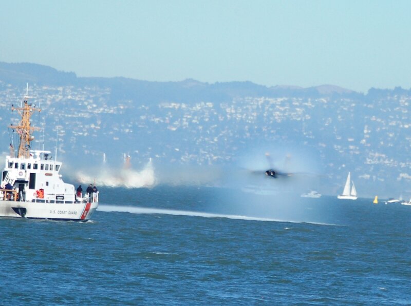 Coast Guard boat near jet over water