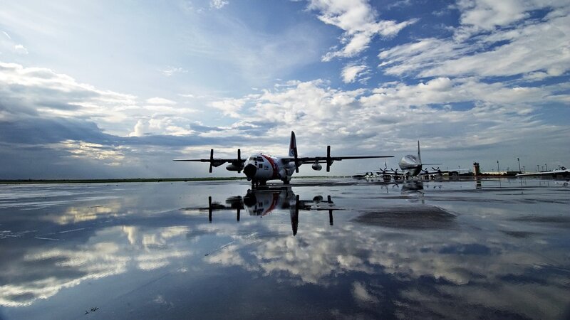 Coast Guard plane on wet tarmac