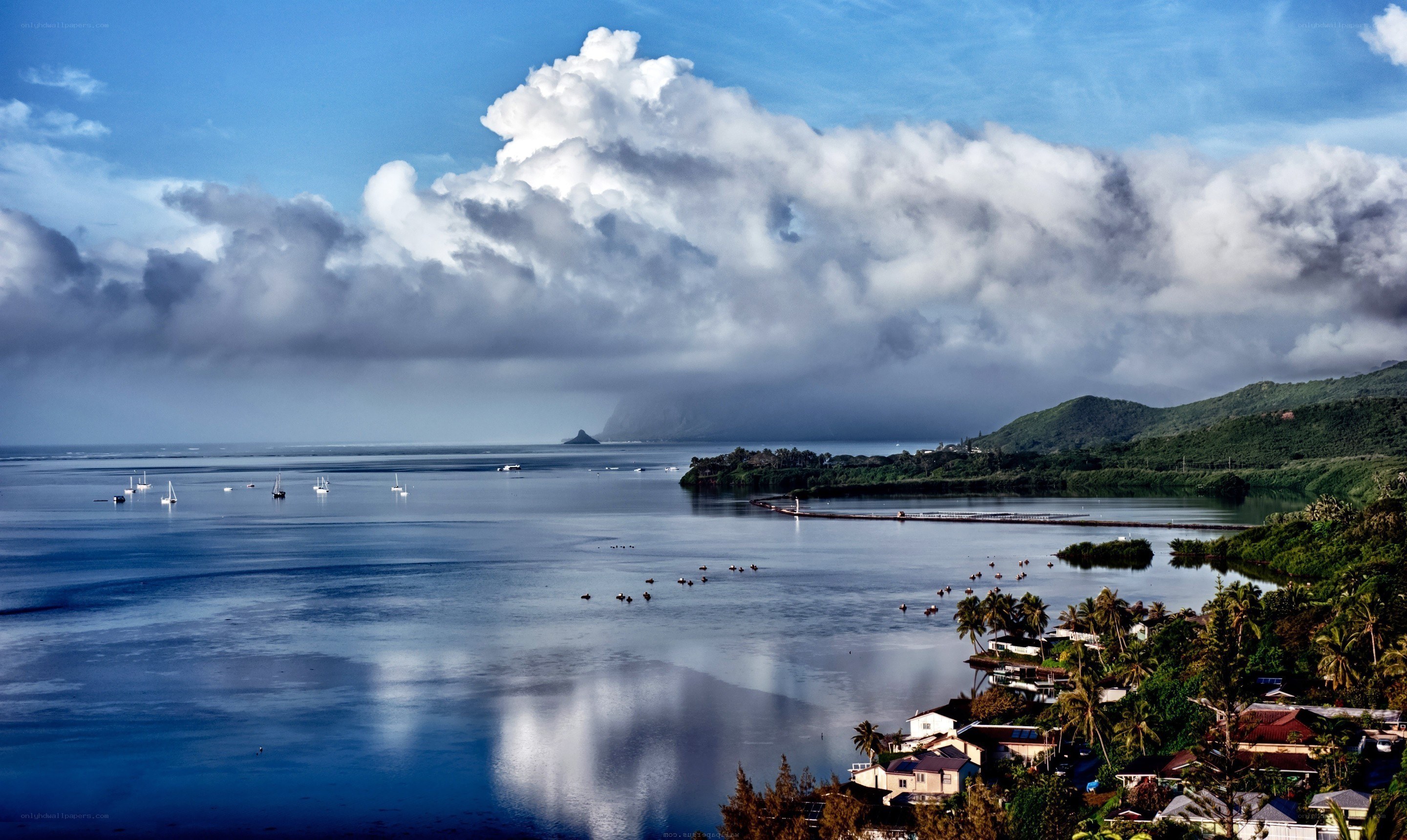 Coastal bay with boats and clouds