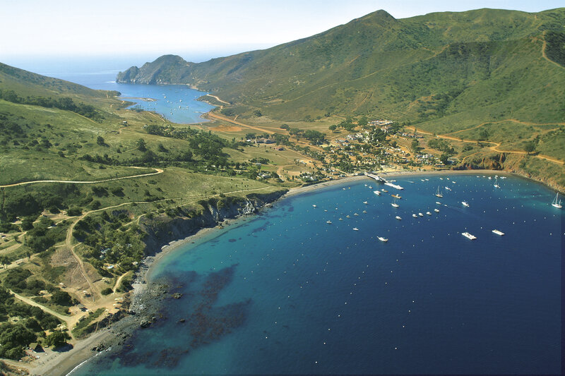 coastal bay with boats and hills