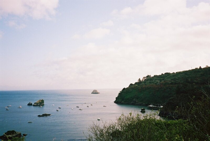 coastal bay with boats and rocks