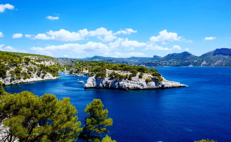 Coastal Bay with Boats — Blue, Serene, Afternoon, Photograph, Cliffs