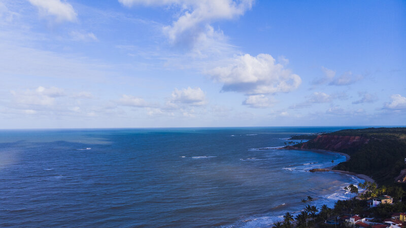 Coastal Bay with Cliffs — Blue, Serene, Afternoon, Photograph, Ocean, Palm Trees