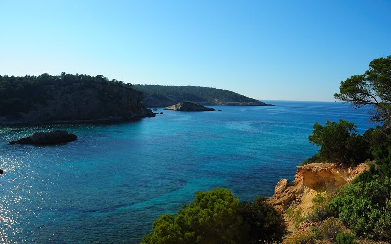 Coastal Bay with Cliffs — Blue, Serene, Afternoon, Photograph, Trees, Rocks, Green
