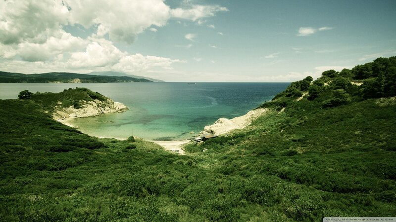 coastal bay with green hills