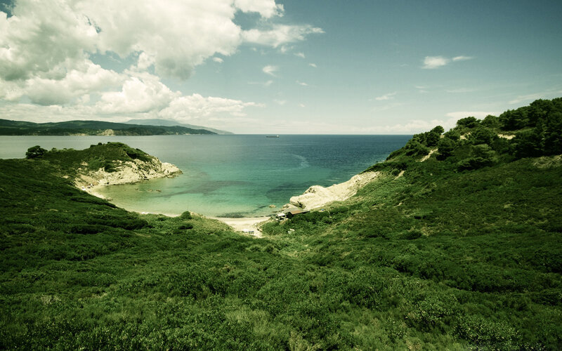 Coastal Bay with Green Hills — Serene