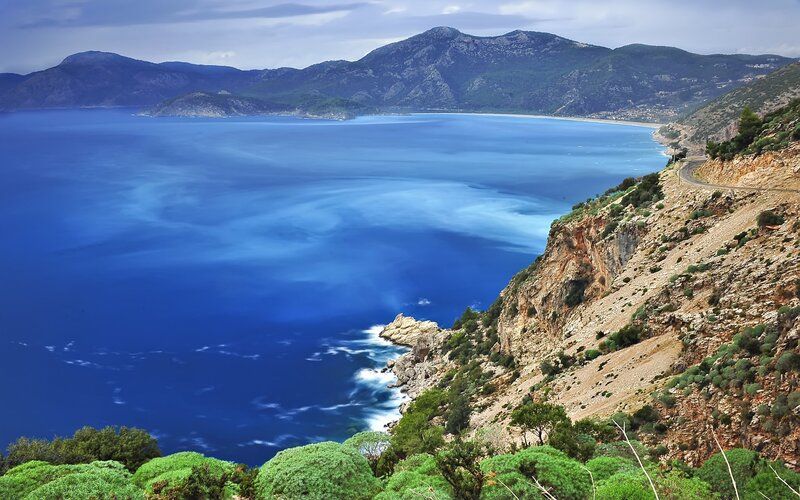Coastal Bay with Mountains — Blue, Serene, Afternoon, Photograph, Sea, Road