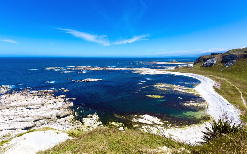 Coastal Bay with Rocks — Blue, Serene, Afternoon, Photograph, Ocean, Beach, Grass