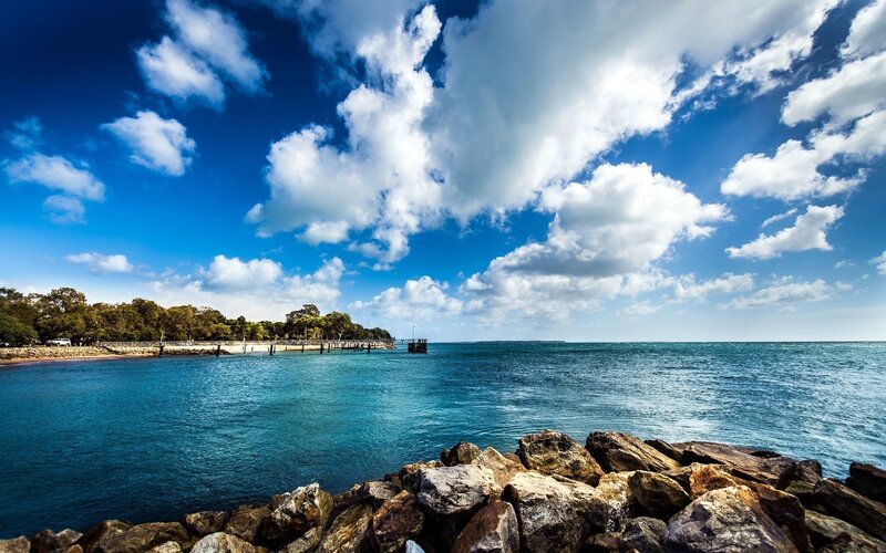 Coastal Bay with Rocks — Blue, Serene, Afternoon, Photograph, Pier, Trees