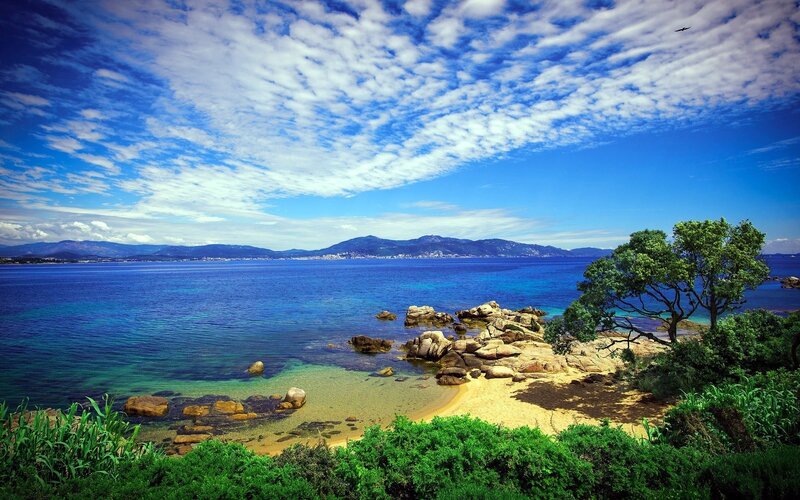 Coastal Bay with Rocks — Blue, Serene, Afternoon, Photograph, Tree, Mountains, Green