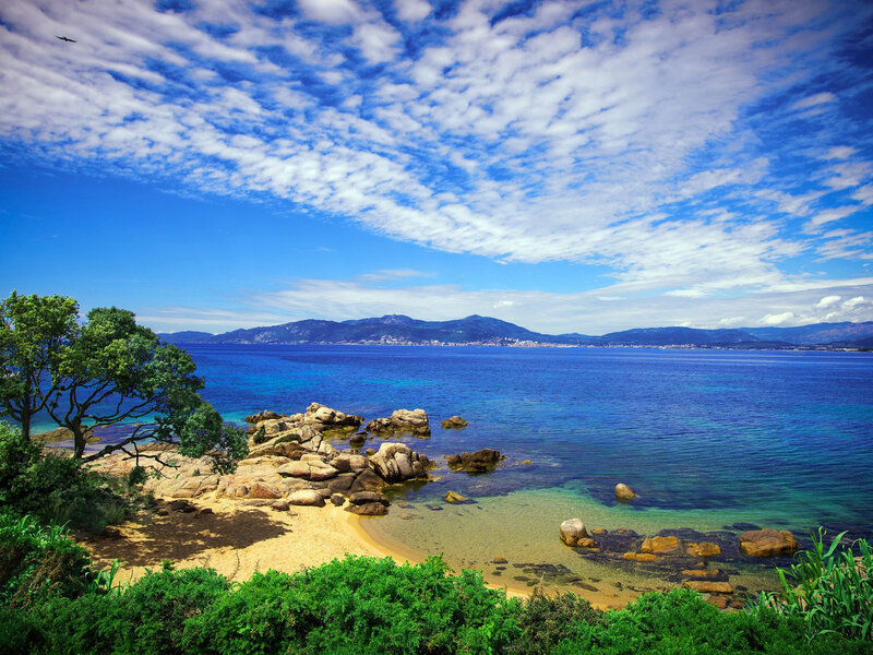 Coastal Bay with Rocks — Blue, Serene, Afternoon, Photograph, Trees, Mountains