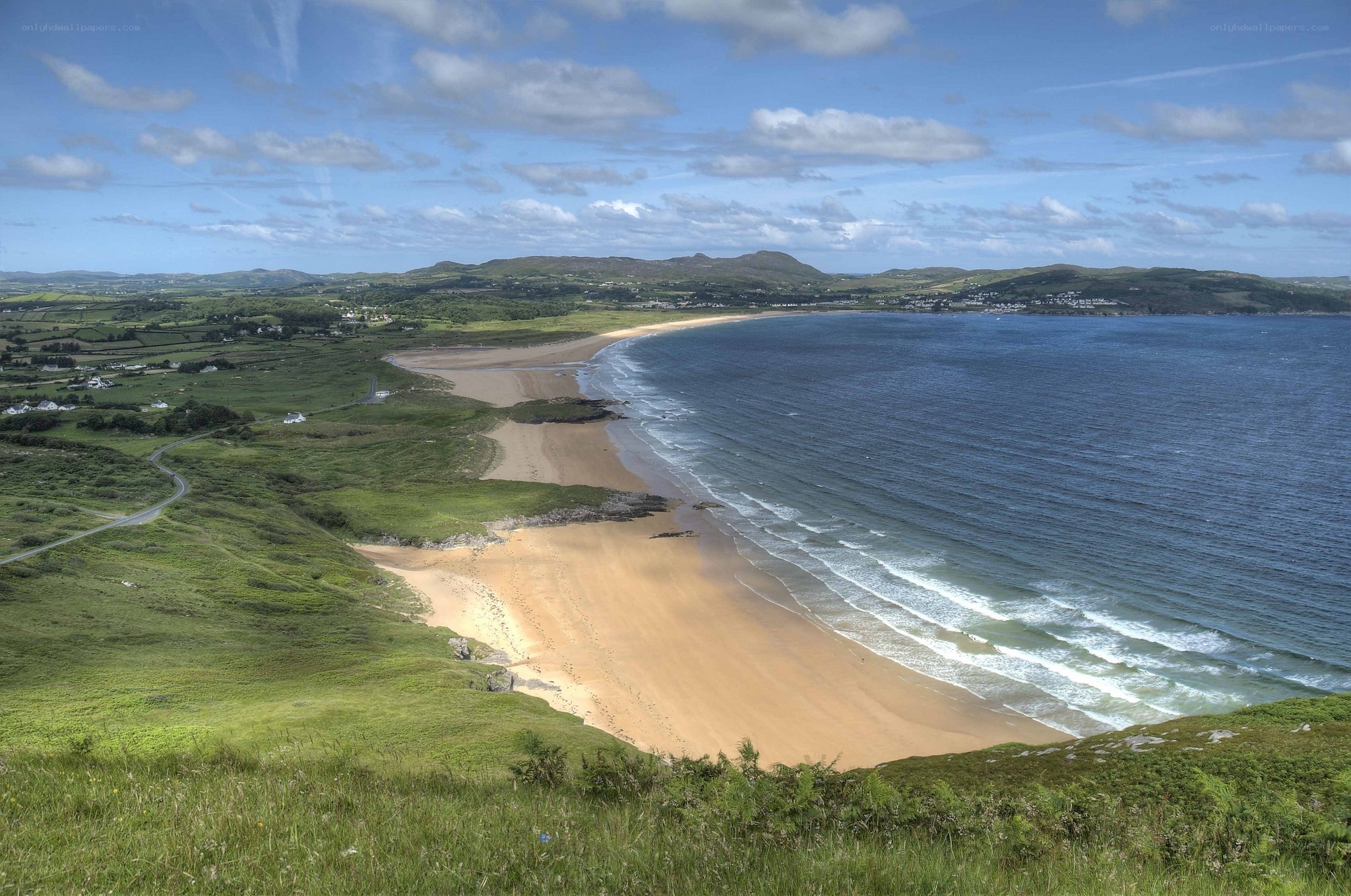 coastal beach with rolling hills