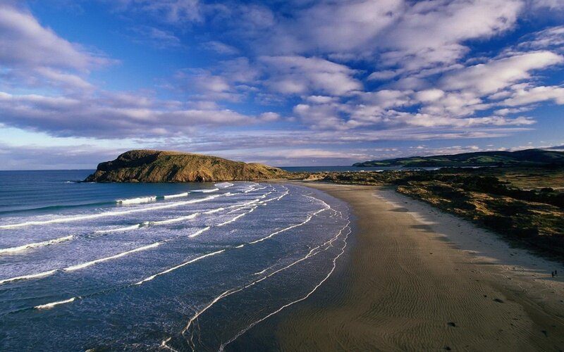 coastal beach with waves and cliffs
