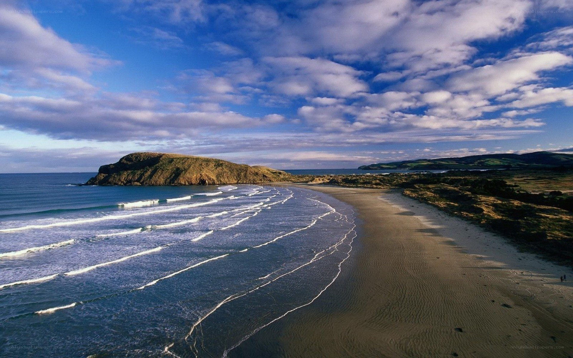 coastal beach with waves and cliffs