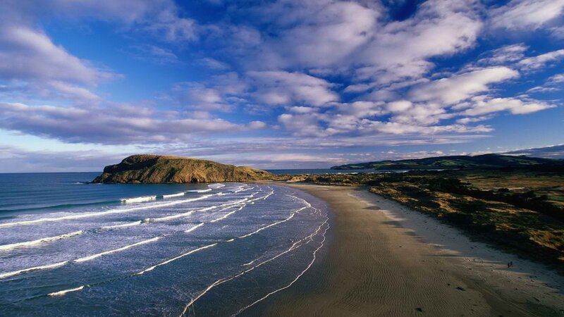 coastal beach with waves and cliffs