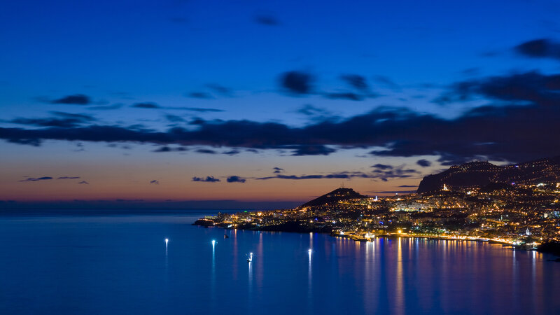 Coastal City at Night — Blue, Serene, Photograph, Mountain, Sea