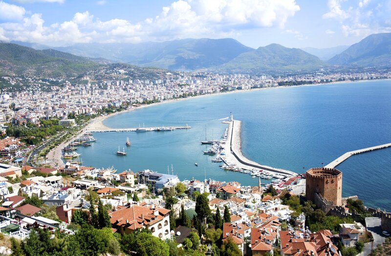 coastal city with harbor and mountains