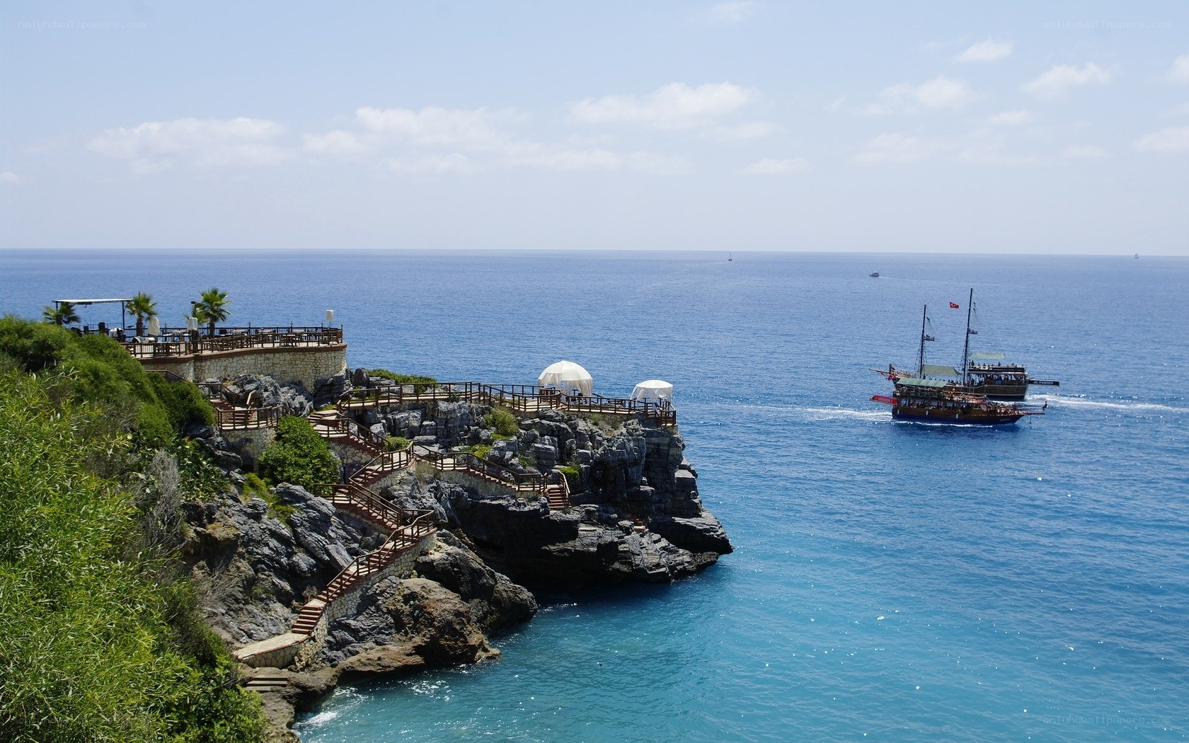 Coastal cliff with boat in sea