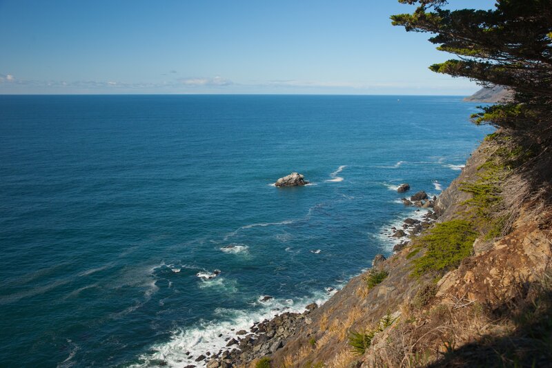 Coastal Cliff with Ocean — Blue, Serene, Afternoon, Photograph, Rock