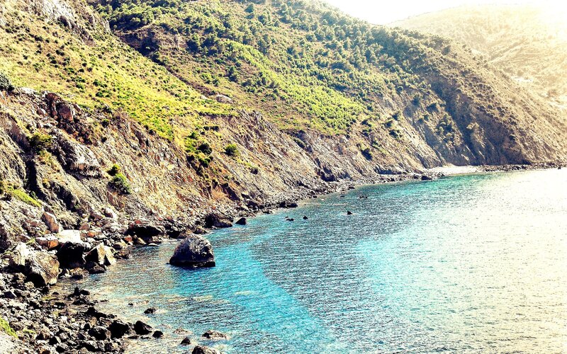 Coastal Cliff with Turquoise Water — Blue, Serene, Afternoon, Photograph