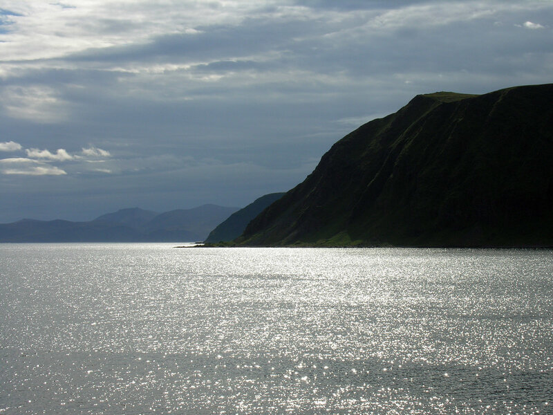 coastal cliffs under cloudy sky